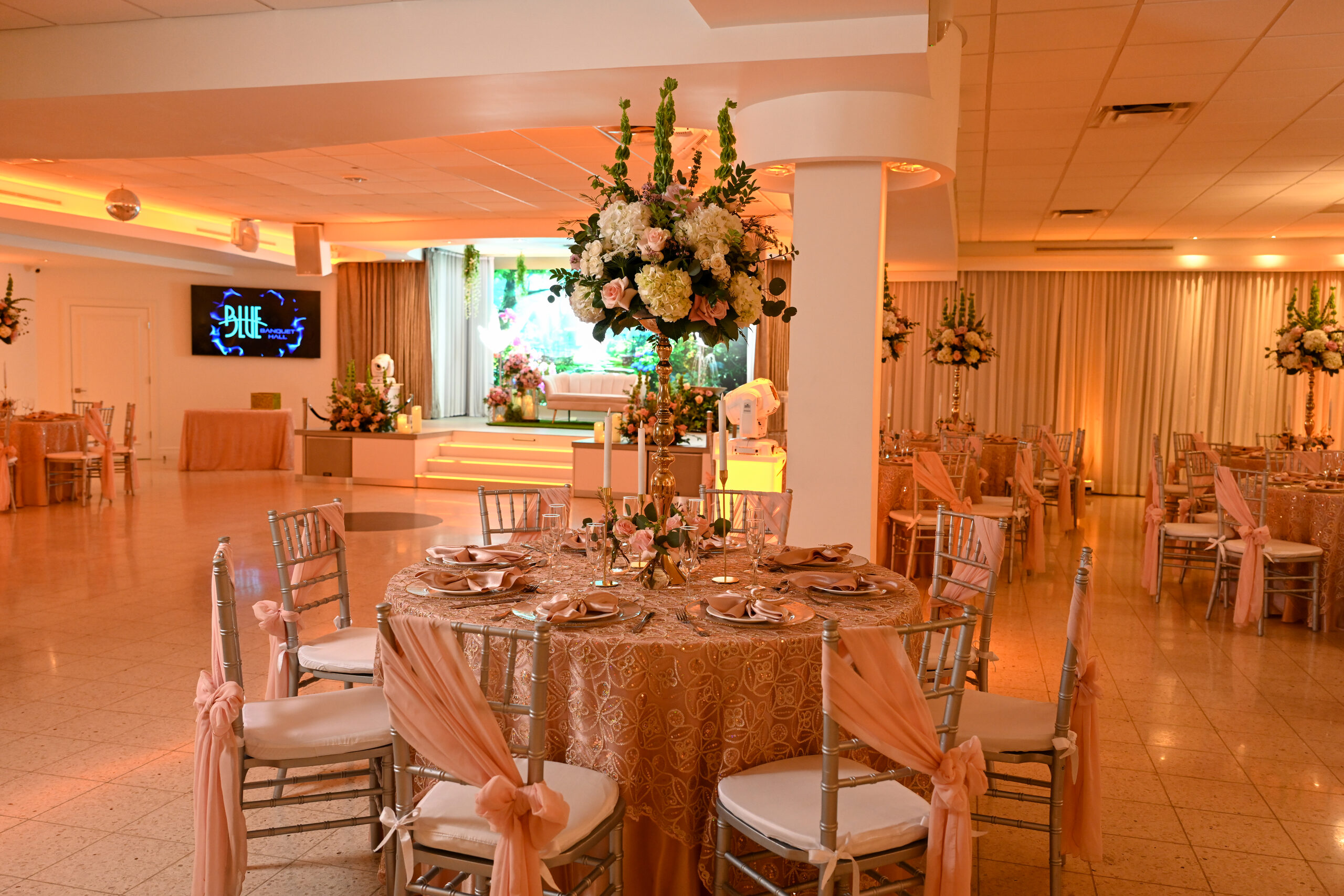 The hall dressed in blush and gold for a quinceañera
