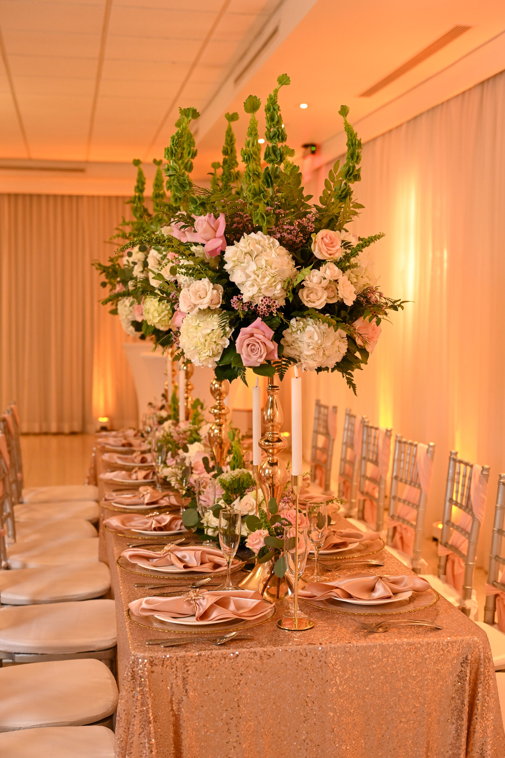 A long formal table with tall florals